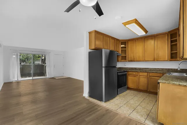 a kitchen with a refrigerator sink and cabinets