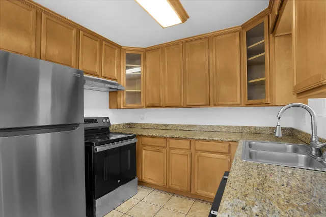a kitchen with a refrigerator sink and stove