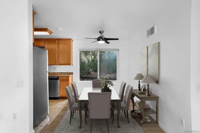 a dining room with furniture a chandelier and wooden floor