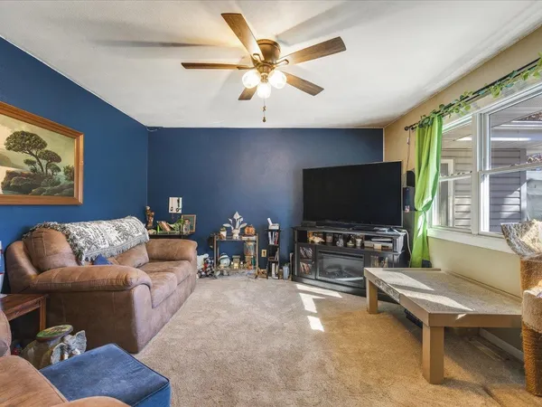 a spacious bedroom with a bed and a chandelier
