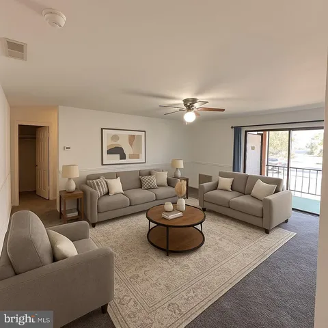a living room with furniture a rug and a large window