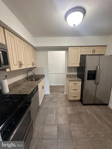 a kitchen with a stove and a sink