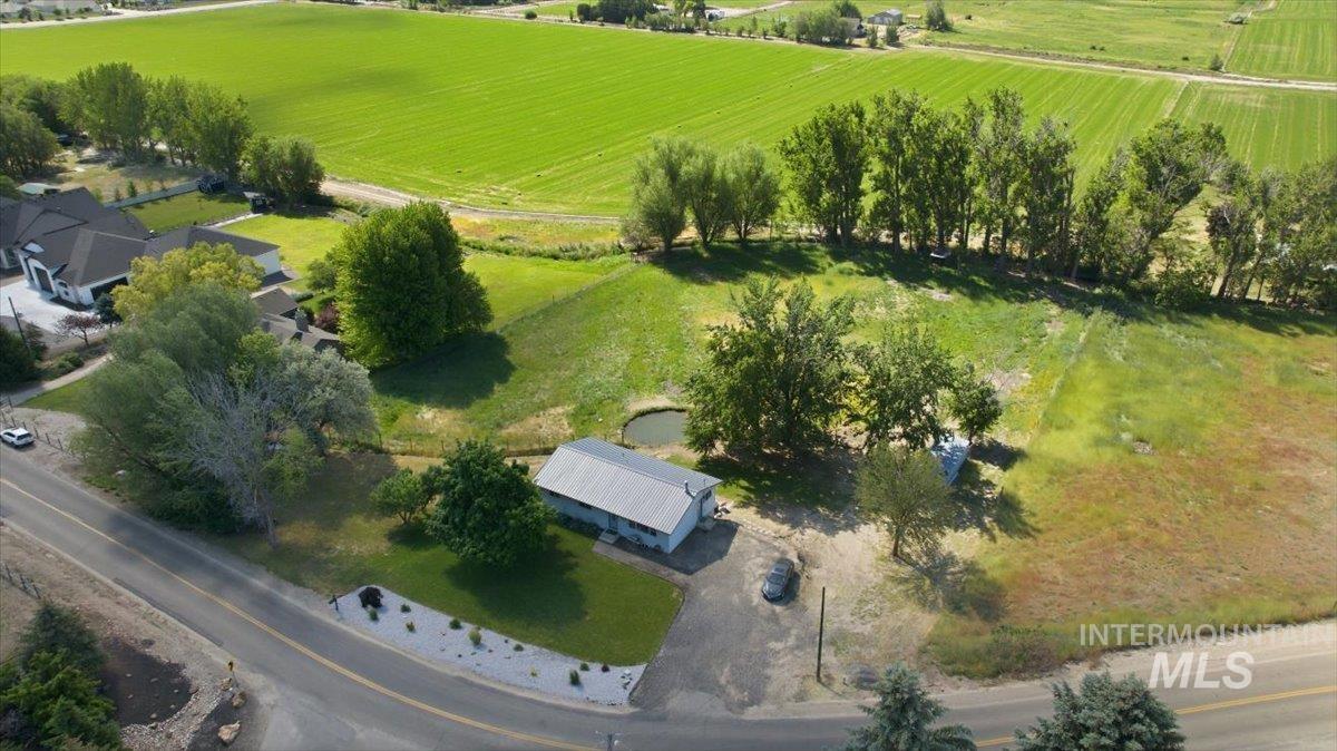 6323 Foothill Road Star, ID 83669 - Photo 44 of 50 Expansive property featuring a single-story structure with a metal roof, surrounded by mature trees and lush green fields