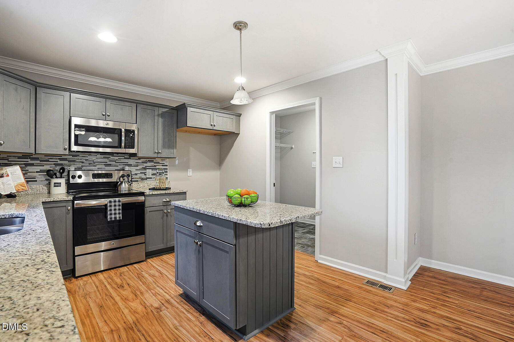 240 North Ridge Drive Louisburg, NC 27549 - Photo 12 of 31 a kitchen with stainless steel appliances granite countertop a stove a refrigerator and a microwave