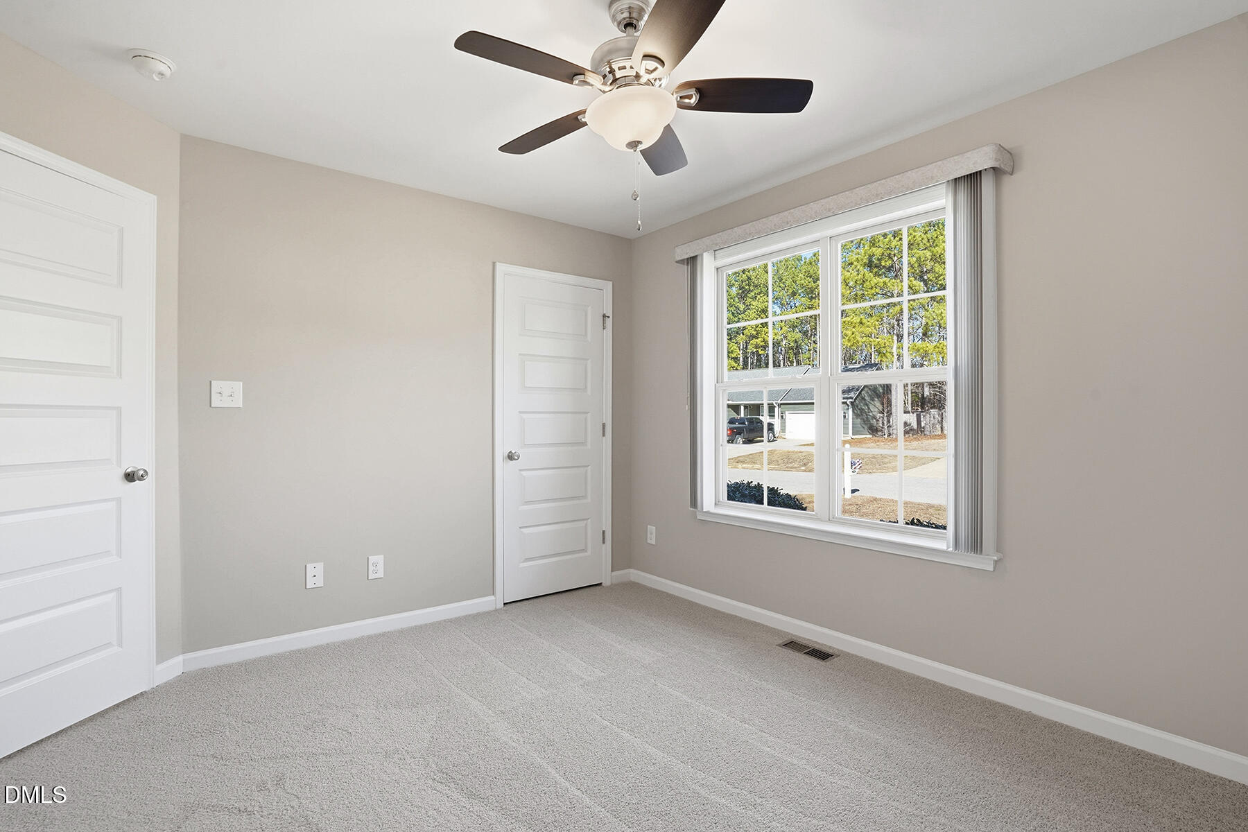 240 North Ridge Drive Louisburg, NC 27549 - Photo 18 of 31 an empty room with chandelier fan and windows