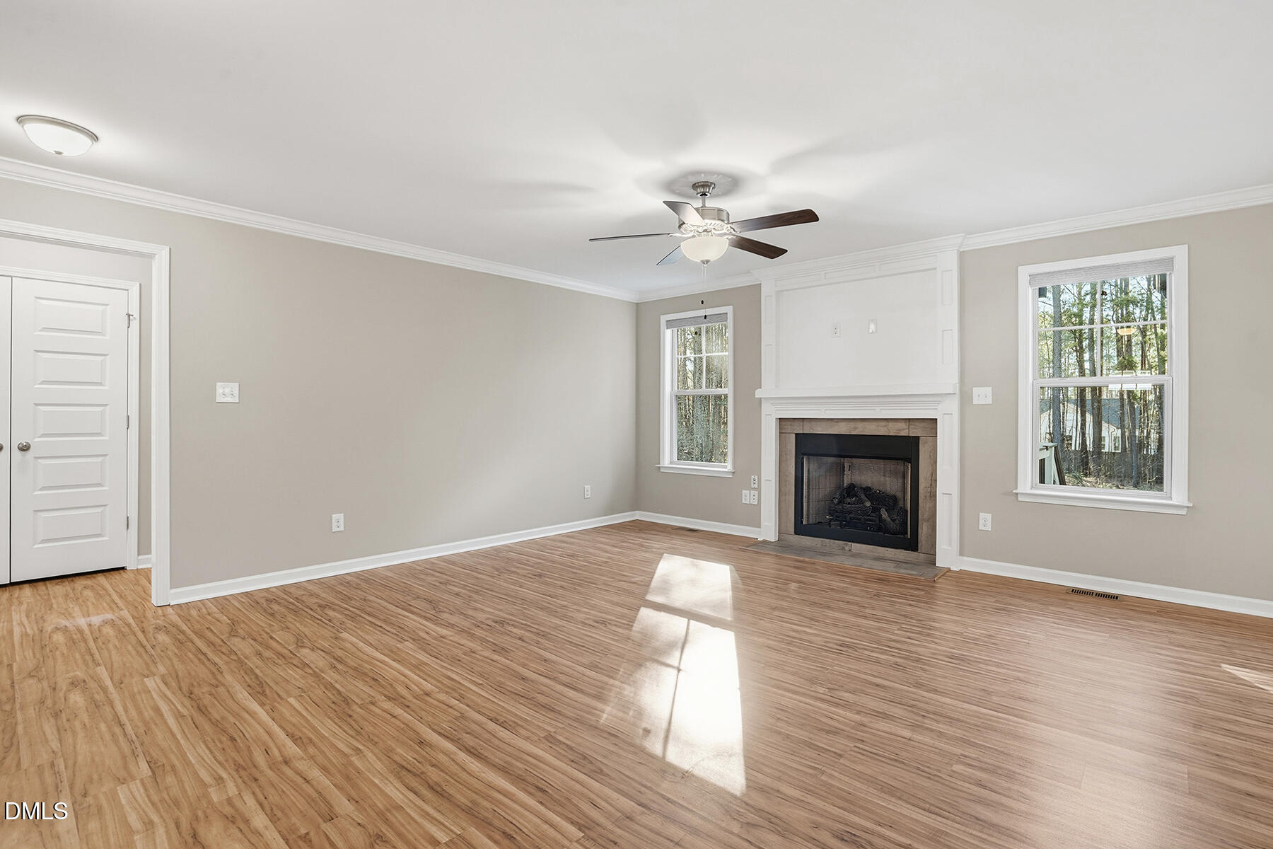 240 North Ridge Drive Louisburg, NC 27549 - Photo 5 of 31 a view of empty room with wooden floor and fireplace