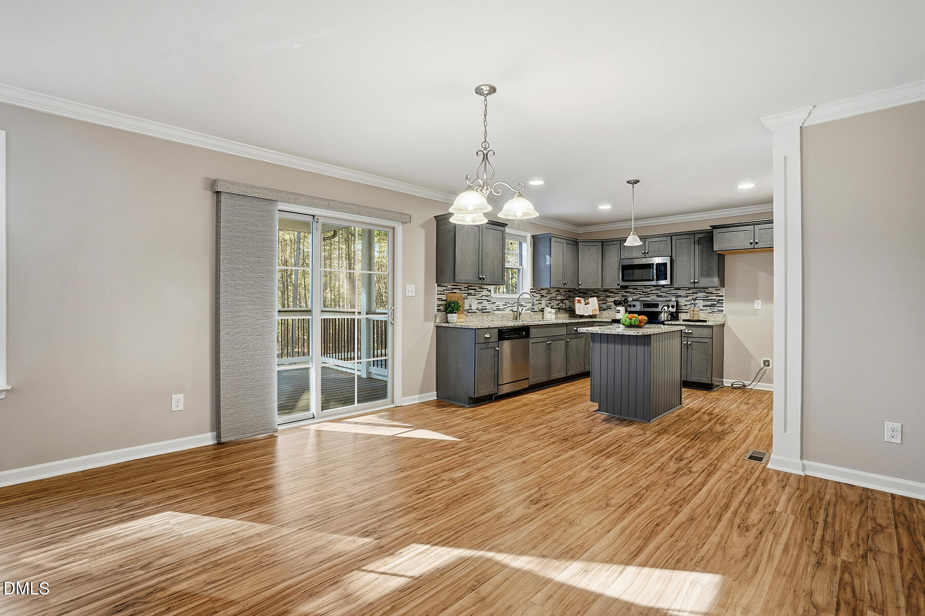 240 North Ridge Drive Louisburg, NC 27549 - Photo 9 of 31 a large kitchen with stainless steel appliances granite countertop a stove a sink dishwasher a refrigerator and a wooden floor