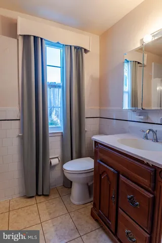 a bathroom with a sink toilet and mirror