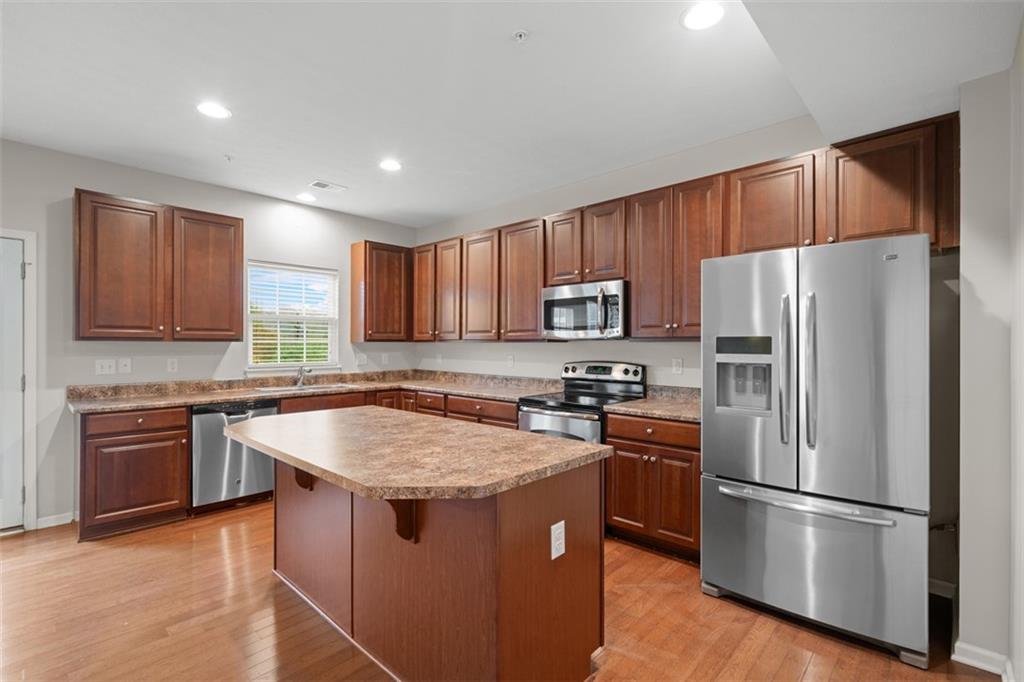 113 Maple Ridge Court Canonsburg, PA 15317 - Photo 11 of 27 a kitchen with stainless steel appliances granite countertop a sink stove microwave and refrigerator