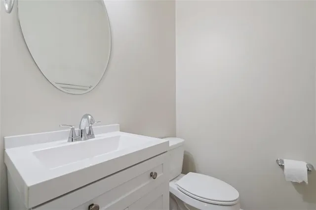 a bathroom with a sink a toilet and mirror