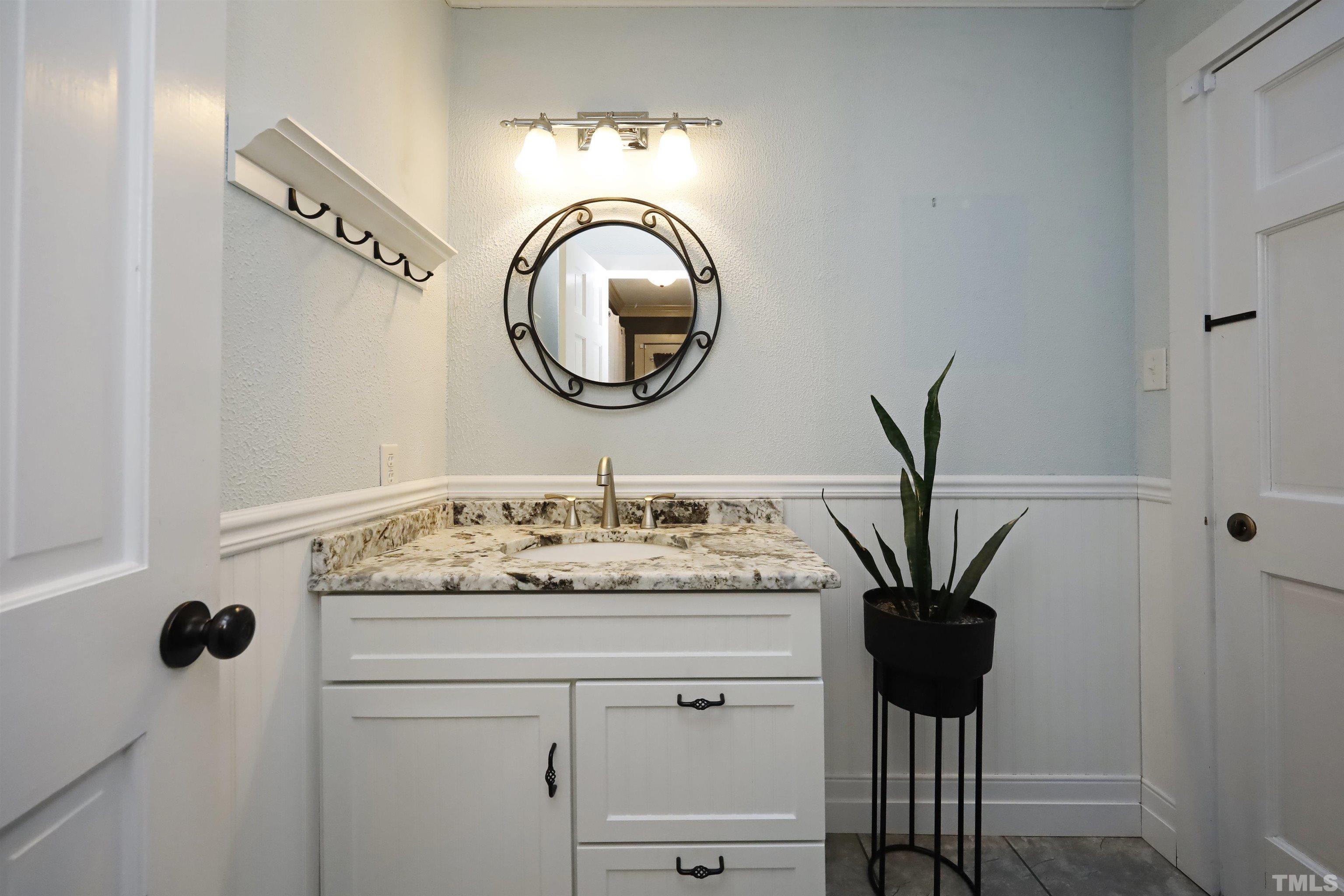 5308 Country Trail Raleigh, NC 27613 - Photo 28 of 51 a bathroom with a sink and a mirror