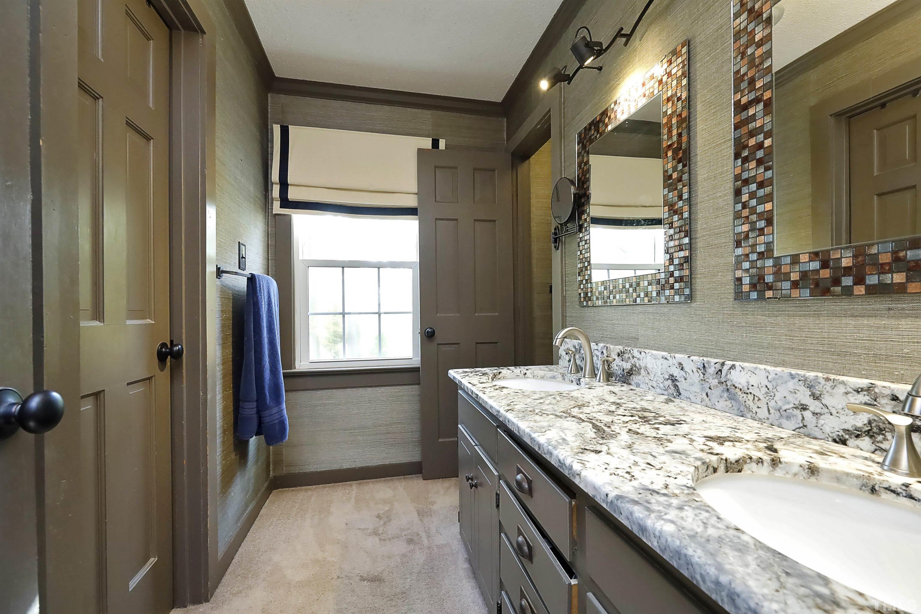 5308 Country Trail Raleigh, NC 27613 - Photo 31 of 51 a bathroom with a granite countertop sink and a mirror
