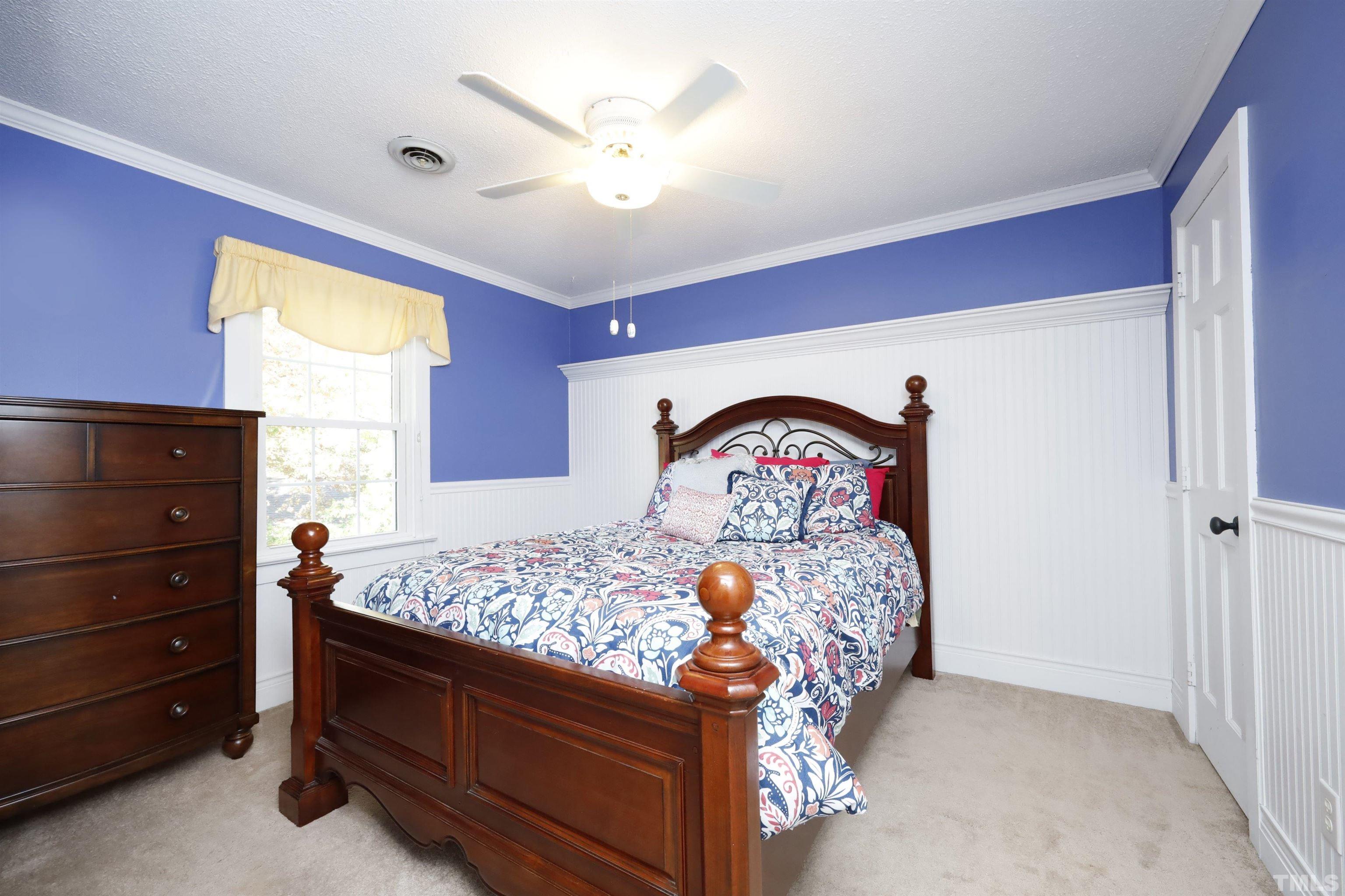 5308 Country Trail Raleigh, NC 27613 - Photo 35 of 51 a bed sitting in a bedroom next to a window