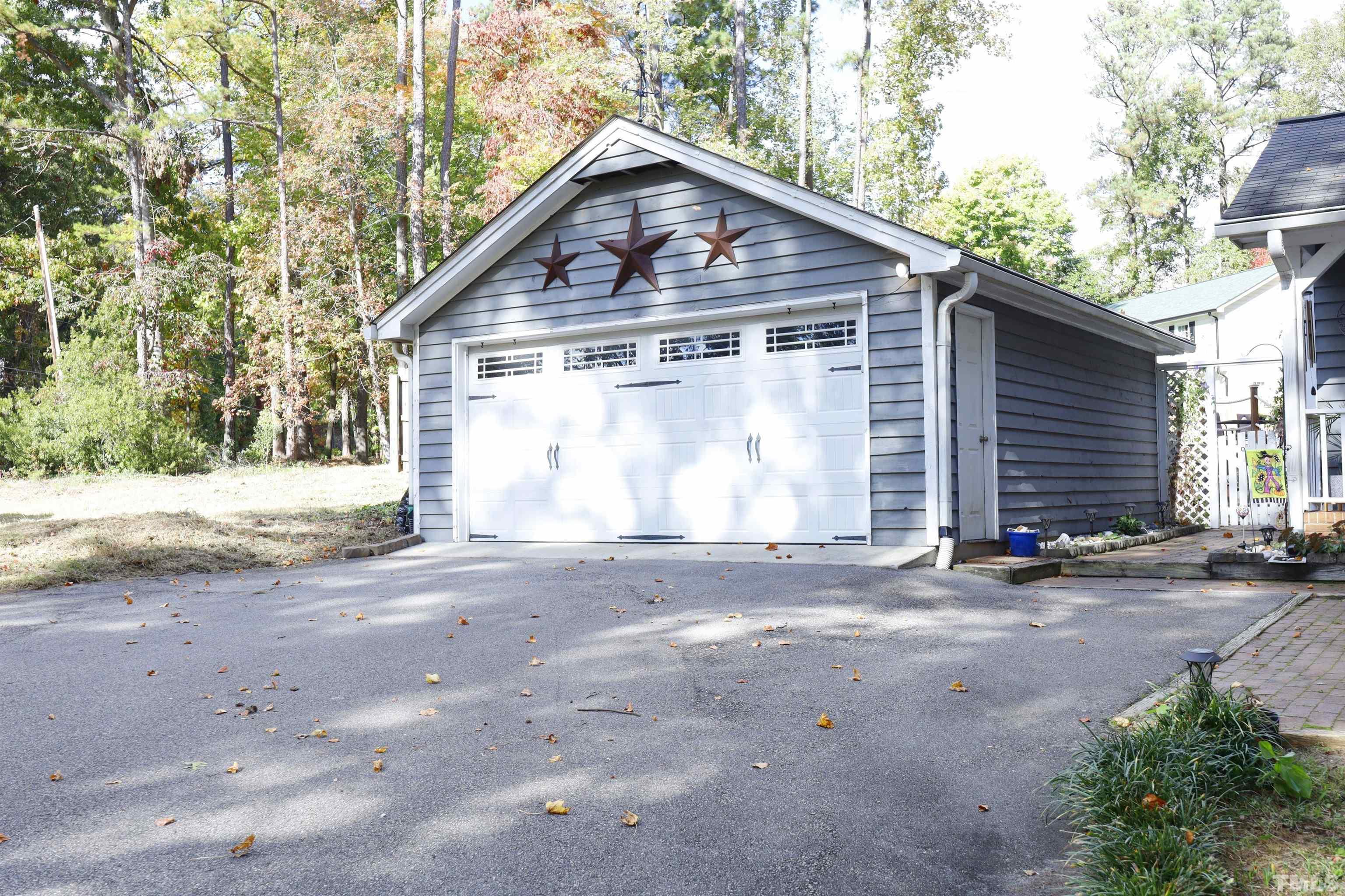 5308 Country Trail Raleigh, NC 27613 - Photo 6 of 51 a front view of a house with a yard and garage