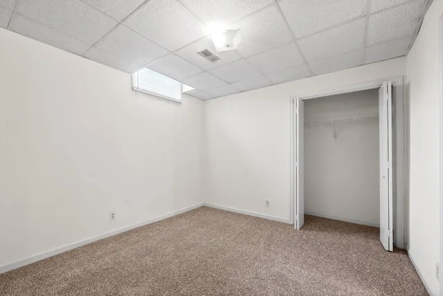 a car parked in front of a brick house