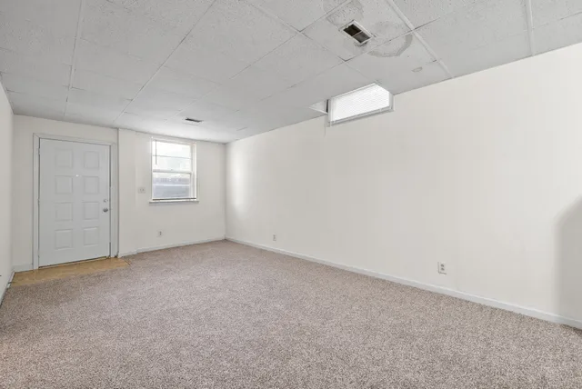 a view of an empty room with a window