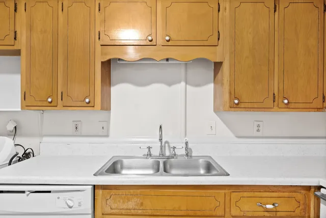 a kitchen with a refrigerator a sink and cabinets