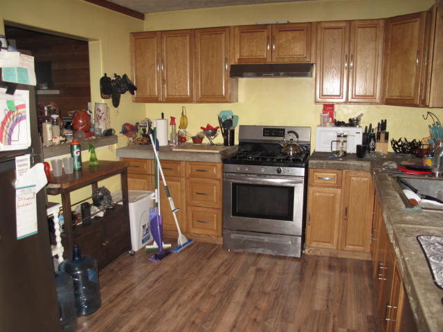 a kitchen with a stove a microwave and wooden cabinets