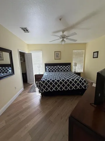 a bedroom with a bed window and a table