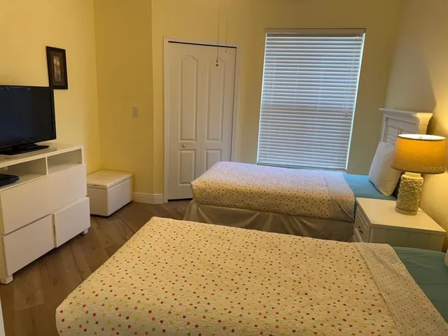 a bedroom with a bed and a flat screen tv
