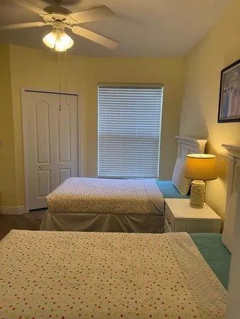 a bedroom with a bed and chandelier