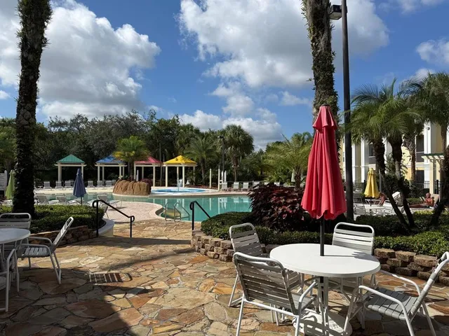 a front view of a house with swimming pool and sitting area