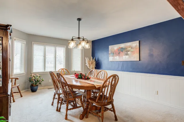 a view of a dining room with furniture and window