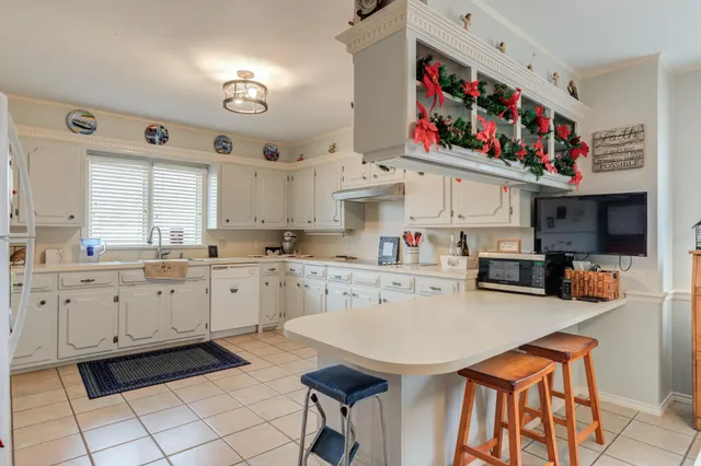 a kitchen with stainless steel appliances granite countertop a sink and cabinets