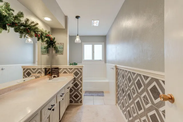 a spacious bathroom with a double vanity sink and a mirror