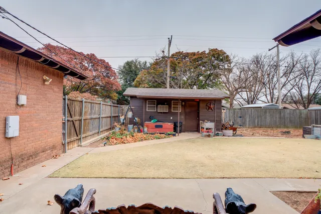 a view of a house with a patio and a yard