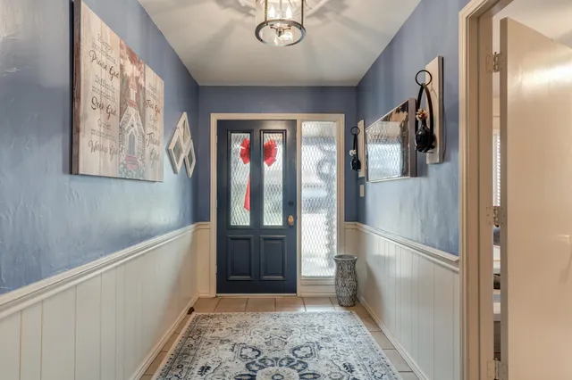 a hallway with sliding door and stairs