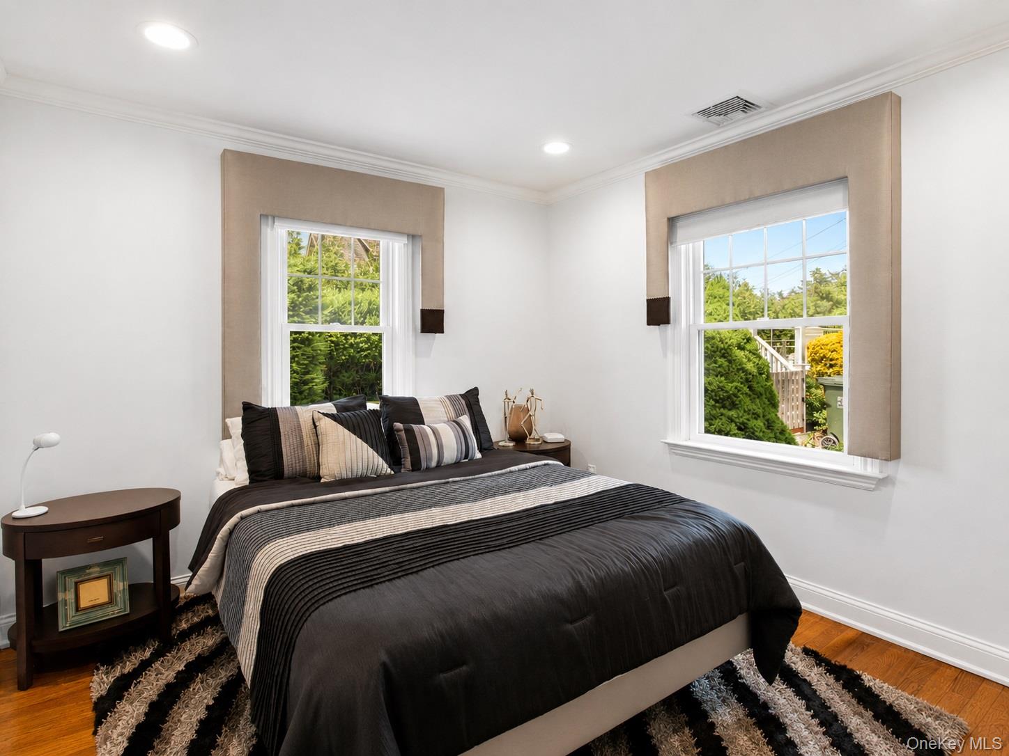 65 Shore Road Westhampton, NY 11977 - Photo 18 of 24 Bright bedroom featuring hardwood flooring, white walls, and recessed lighting