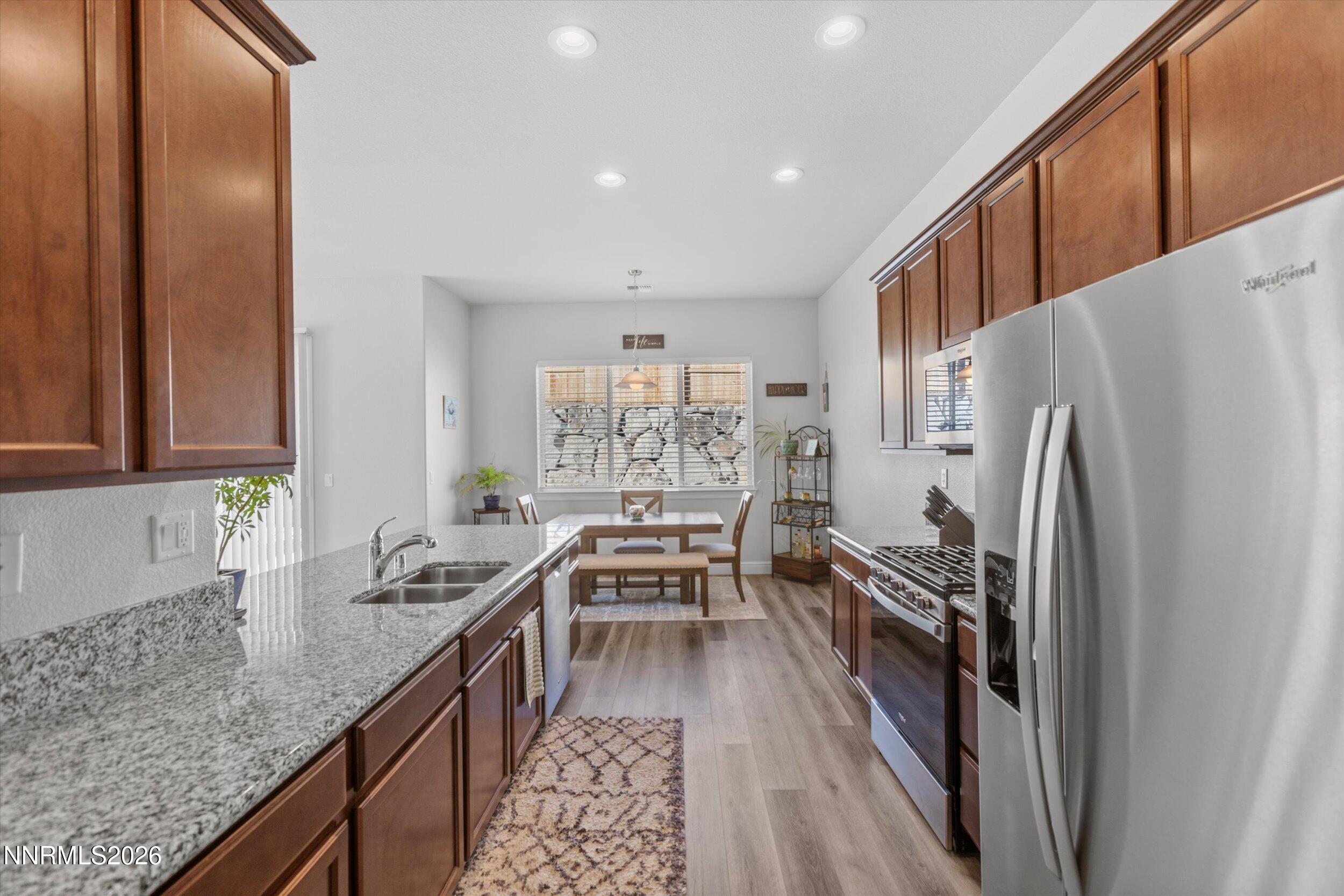 11125 Gallaudet Drive Reno, NV 89506 - Photo 13 of 32 a kitchen with granite countertop a refrigerator stove and sink