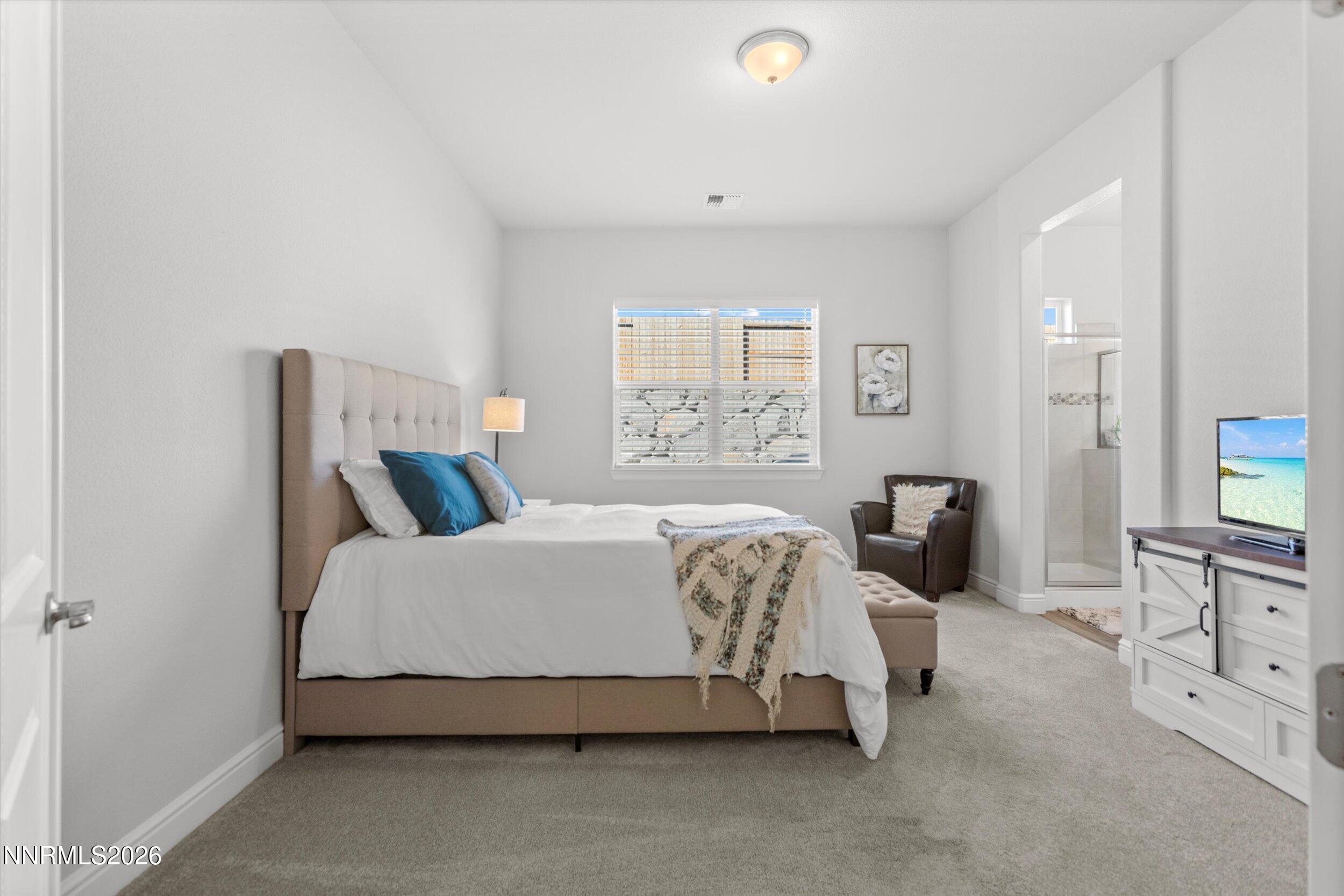 11125 Gallaudet Drive Reno, NV 89506 - Photo 14 of 32 a spacious bedroom with a bed and a cabinets