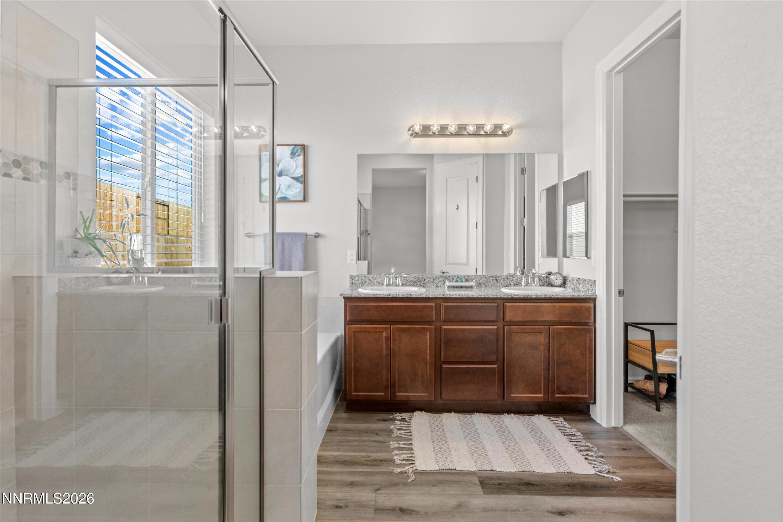 11125 Gallaudet Drive Reno, NV 89506 - Photo 17 of 32 a bathroom with a sink a vanity and a mirror