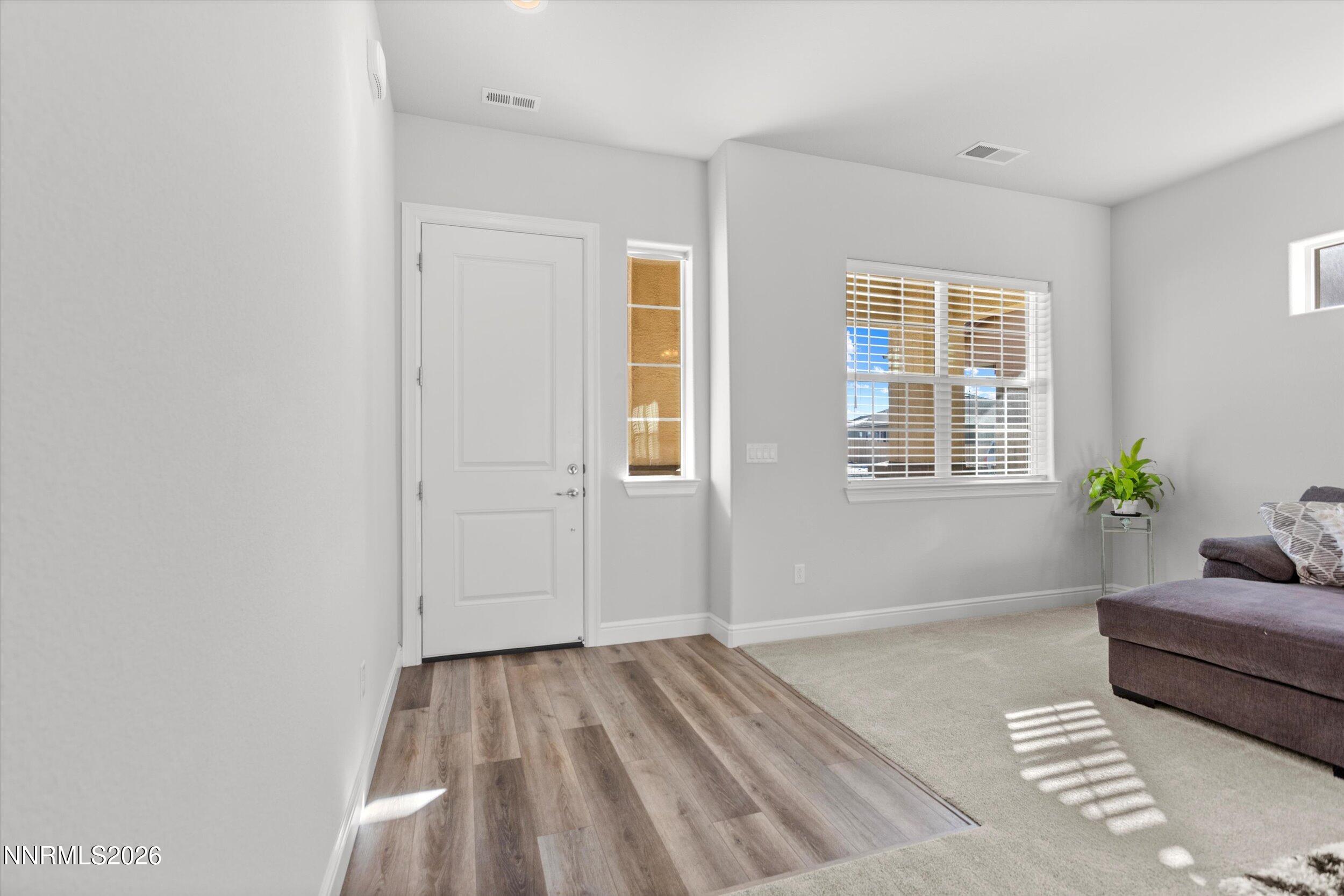 11125 Gallaudet Drive Reno, NV 89506 - Photo 3 of 32 a spacious bedroom with a bed and a couch