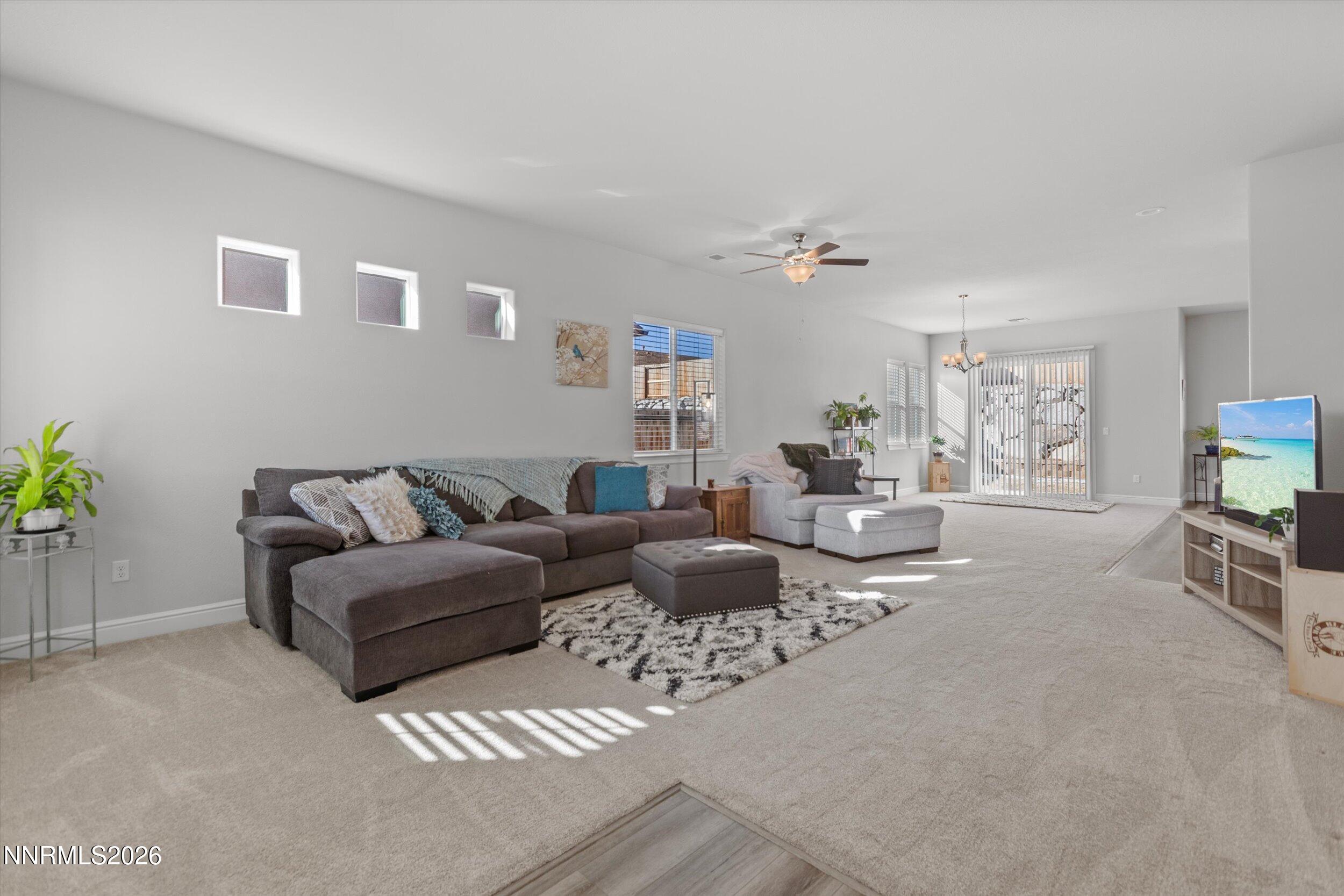 11125 Gallaudet Drive Reno, NV 89506 - Photo 4 of 32 a living room with furniture a flat screen tv and a window