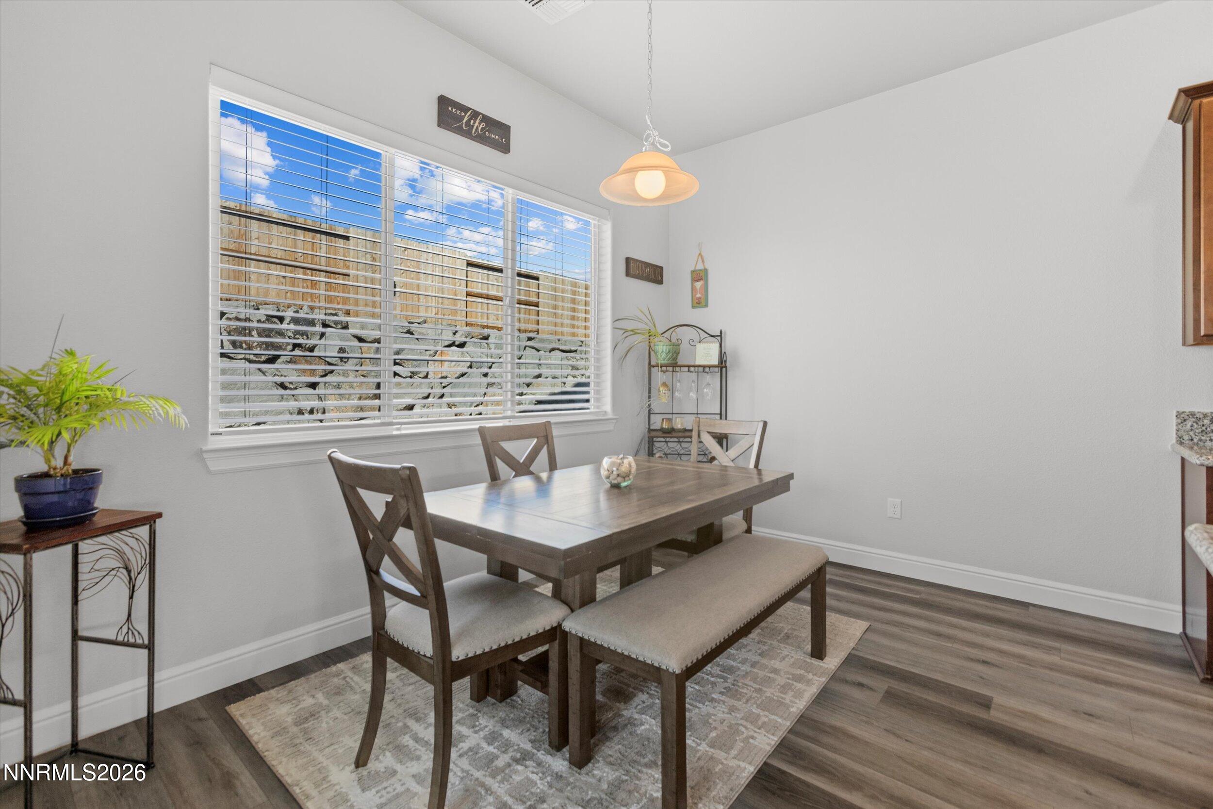 11125 Gallaudet Drive Reno, NV 89506 - Photo 9 of 32 a view of a dining room with furniture and wooden floor