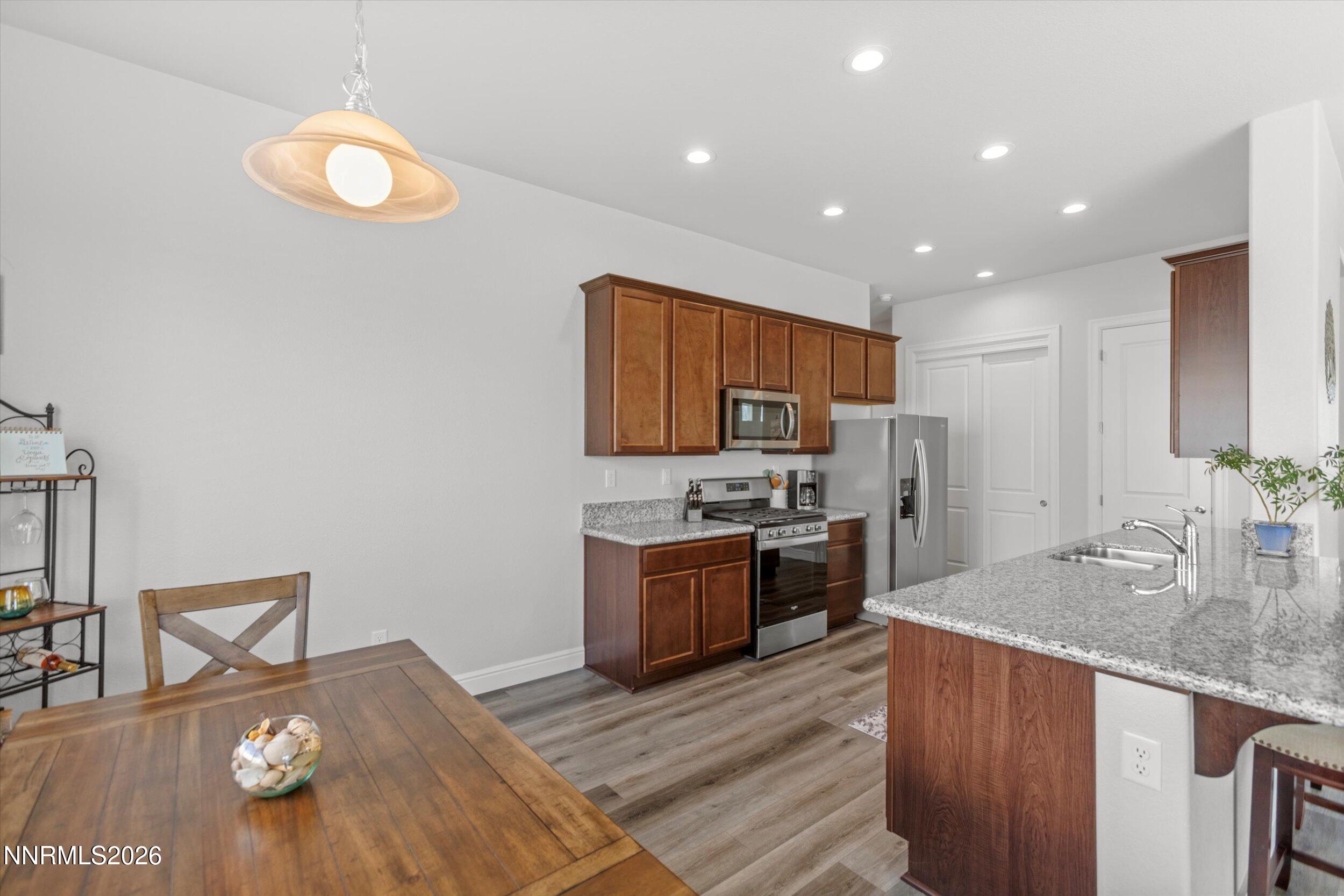 11125 Gallaudet Drive Reno, NV 89506 - Photo 10 of 32 a kitchen with stainless steel appliances granite countertop a sink stove and refrigerator