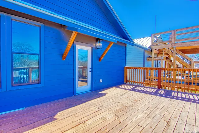a view of a house with wooden fence