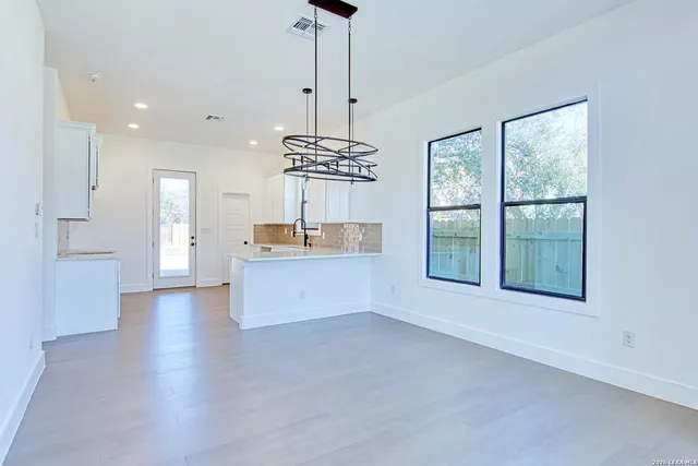 a view of kitchen with refrigerator and window
