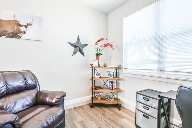 a bedroom with furniture and a wooden floor