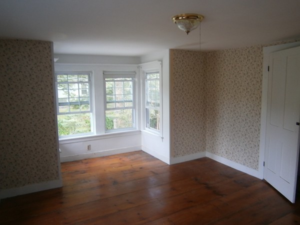 125 West Main Street Rindge, NH 03461 - Photo 11 of 19 an empty room with wooden floor and windows