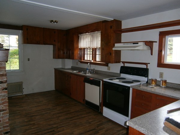 125 West Main Street Rindge, NH 03461 - Photo 7 of 19 a kitchen with granite countertop a stove sink and cabinets