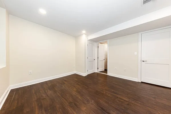an empty room with wooden floor