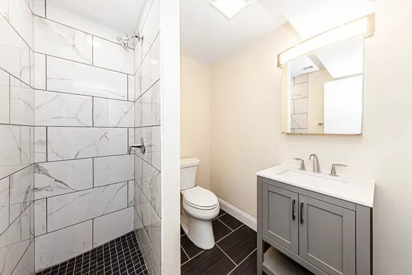 a bathroom with a sink toilet and shower