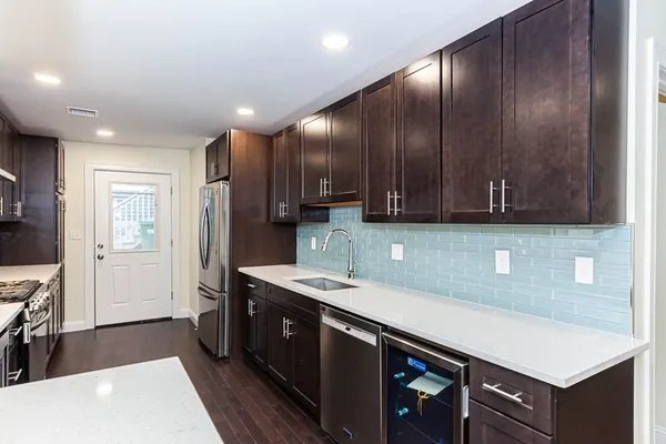 a kitchen with stainless steel appliances granite countertop a sink stove and cabinets