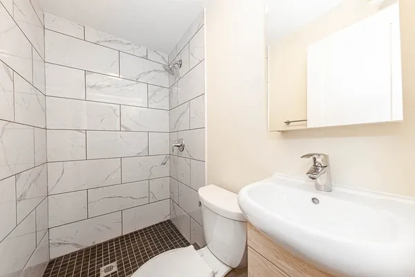 a bathroom with a sink toilet and shower