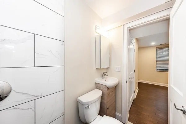 a bathroom with a toilet sink and mirror