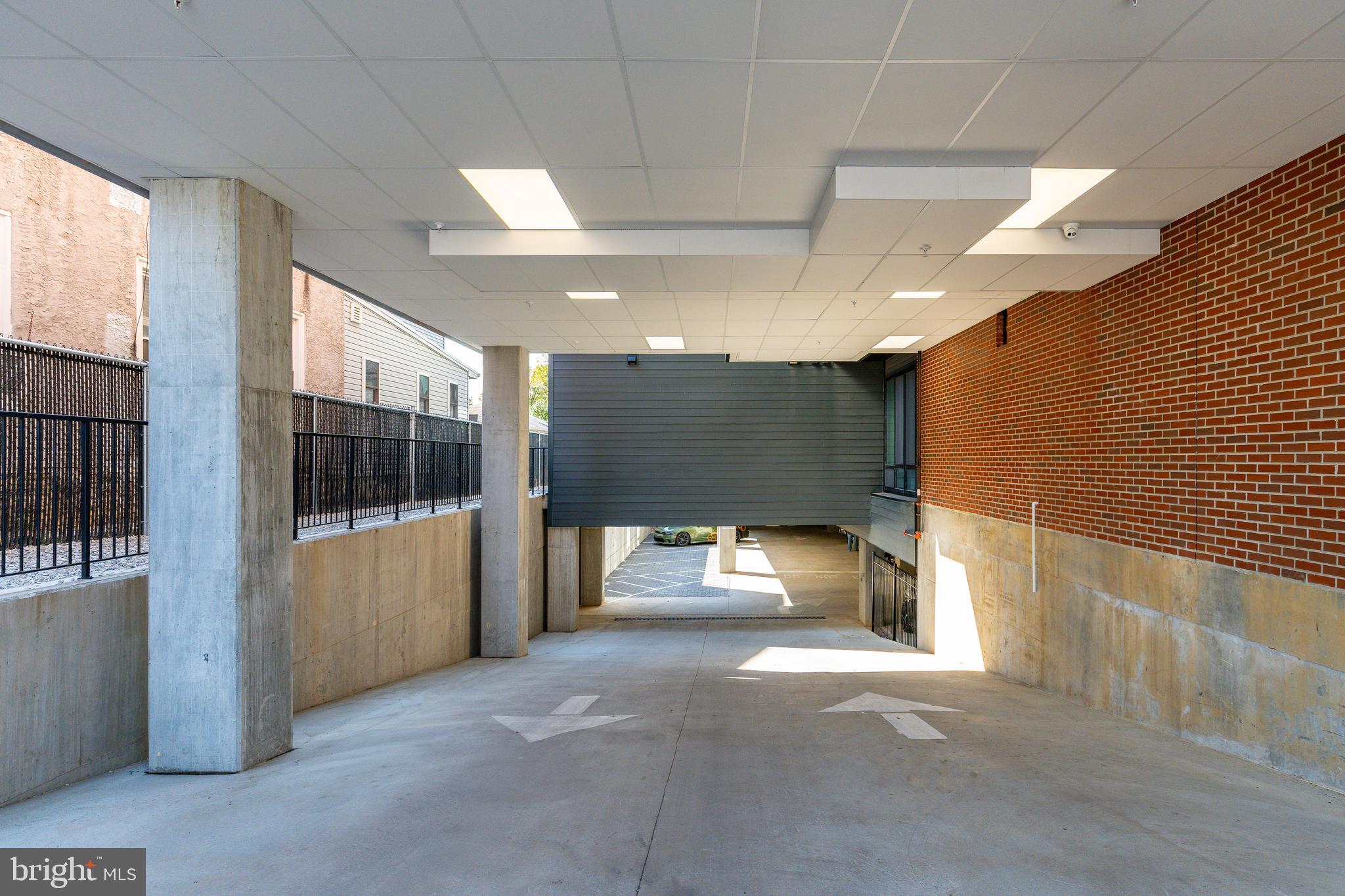 6910 Ridge Avenue, Unit 409 Philadelphia, PA 19128 - Photo 14 of 21 a view of a hallway with a couch and chandelier